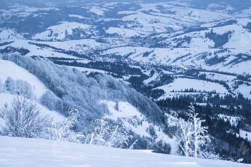 Preview: Fluffy clouds shelter under white snow sheltered by forests and beautiful mountains