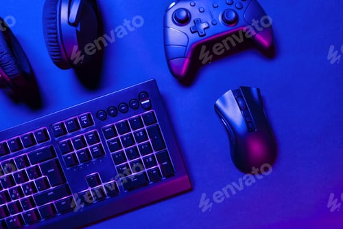 Preview: Pink illuminated gaming gadgets on desk