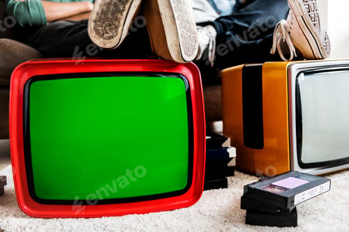 Preview: Two man sitting and two retro television