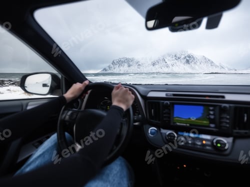 Preview: Driver at the wheel of a car. The view from inside the car on the road and landscape
