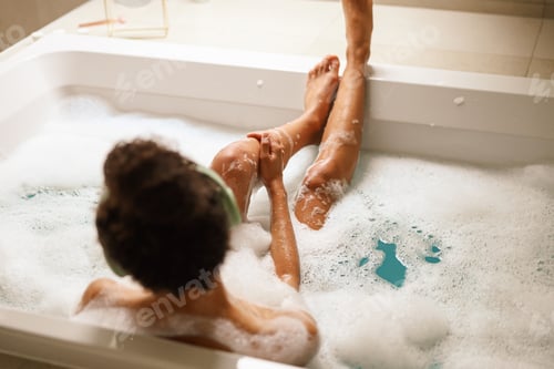 Preview: A young woman is happily bathing in a bathtub