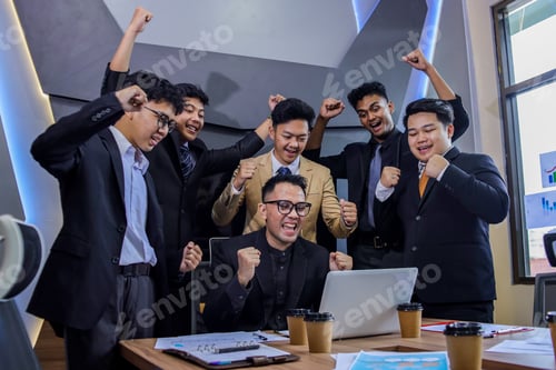 Preview: Diverse Group Of Young Asian Professionals Celebrating Triumph In Modern Corporate Office