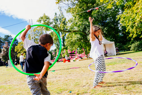 Preview: Girl (6-7) and boy playing with hula hoops