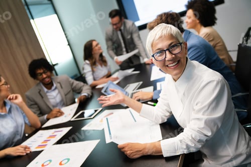 Preview: Business colleagues in conference meeting room during presentation