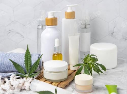 Preview: Blank cosmetic jars, tubes and bottles near green cannabis leaves close up, CBD cosmetic mockup