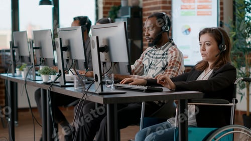 Preview: Female worker in wheelchair working on telecommunications
