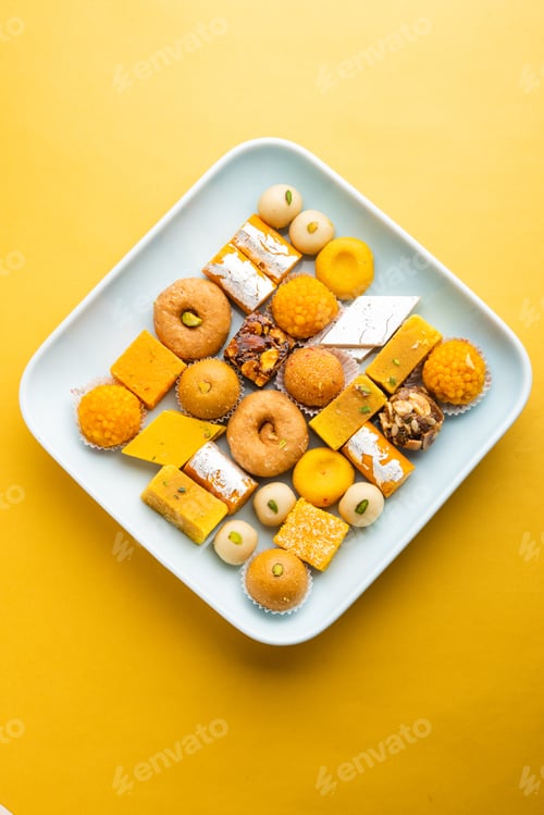 Preview: Group of Indian assorted sweets or mithai with diya