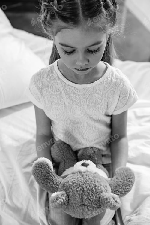 Preview: black and white photo of upset girl with teddy bear in hospital chamber