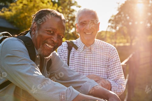 Preview: Portrait Of Two Male Senior Friends Hiking In Countryside