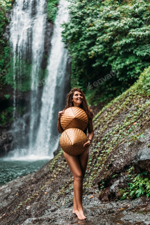 Preview: Beautiful girl at a waterfall on the island of Bali Indonesia. Sexy girl at the waterfall