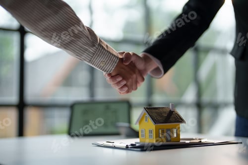 Preview: Real estate agent has entered into a contract to sell the house to the customer handshake congratula