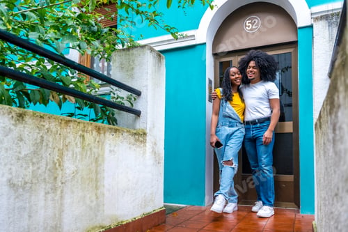 Aperçu: African couple embracing proud in the door of their house