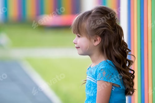 Preview: Profile portrait of little fashionable blond girl in blue dress, with gray eyes and beautiful long