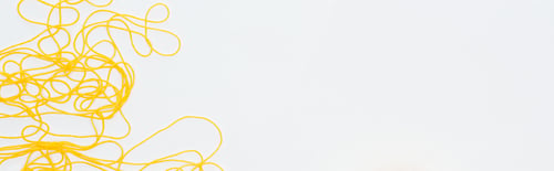 Preview: top view of yellow yarn with copy space Isolated On White