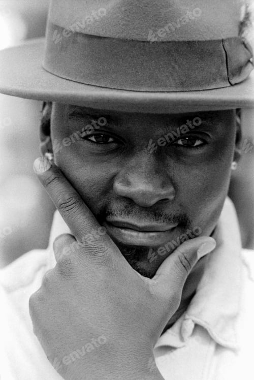 Preview: Funny monochrome close portrait of man with hat looking at camera.