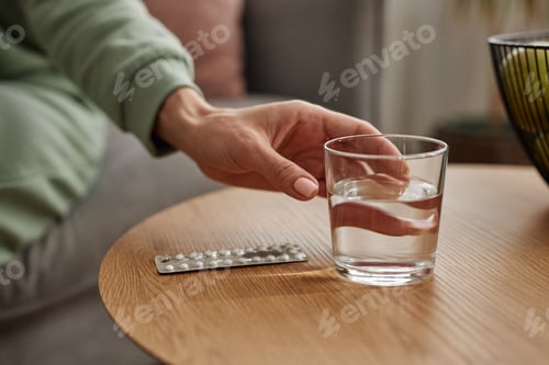 Preview: Close Up of Hand Reaching For Glass of Water
