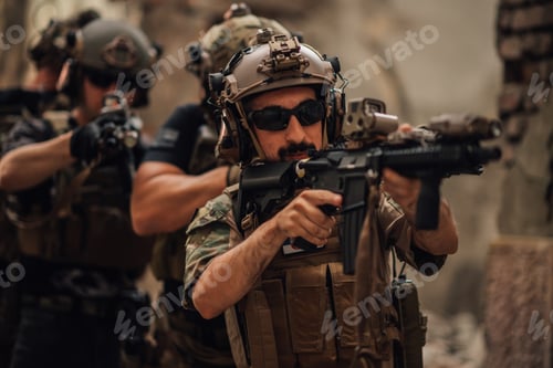 Preview: Portrait of soldier in crowd with rifle going in action at warzone.