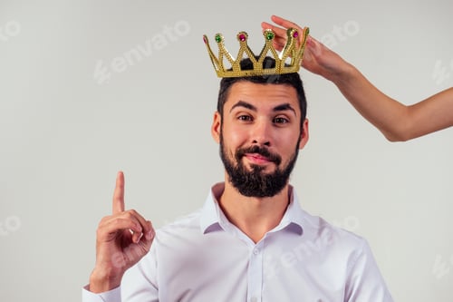 Preview: Portrait of a smiling bearded business man with a golden crown on his head