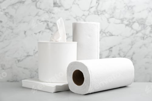 Preview: Clean napkins, box with tissues and rolls of paper towels on light table
