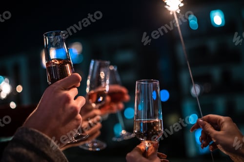 Preview: Festive Champagne Toasting with Sparkler Celebration at Night