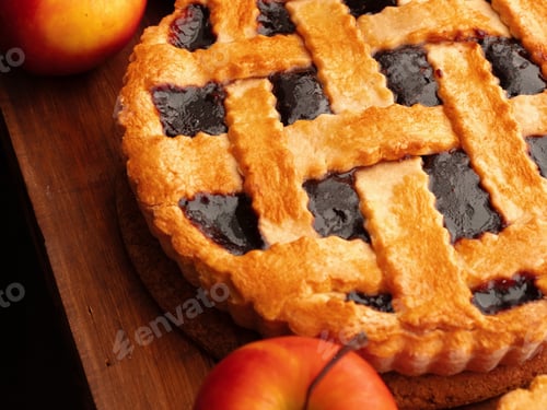 Preview: Baking a pie with fresh apples and a golden crust on a wooden table in the kitchen