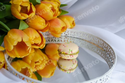Preview: Pastel Macaron Next to Yellow Tulips on Silver Tray