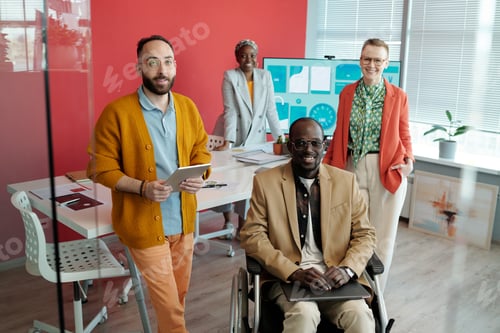 Preview: Diverse Team Posing in Modern Office with Presentation Screen