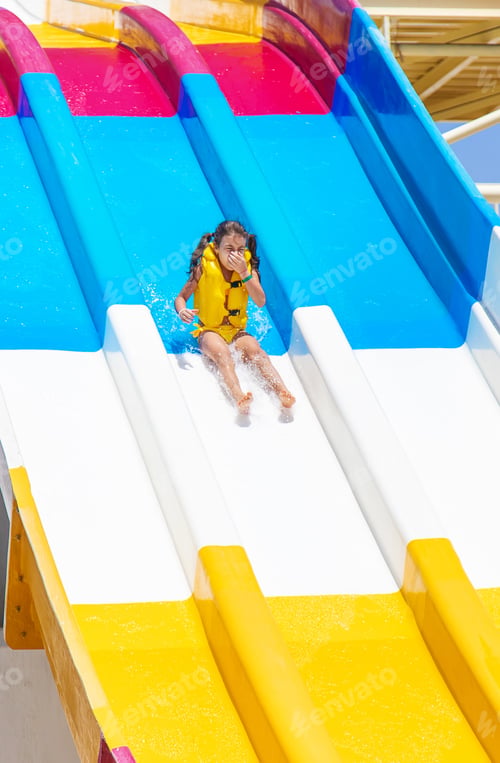 Preview: Children descend from the slides in the water park. Selective focus.