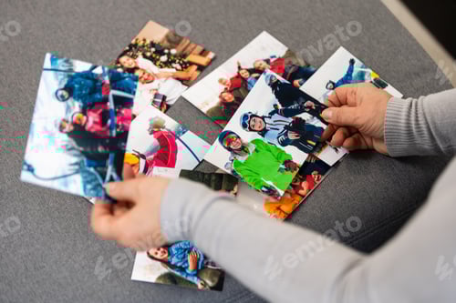 Preview: an elderly woman is looking at a photo of her grandchildren