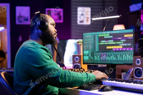 Preview: Man composing music with software in urban studio