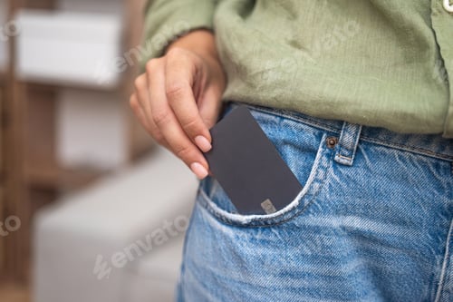 Preview: Lady takes out dark credit card with chip from jeans pocket to make online payment for ordered goods