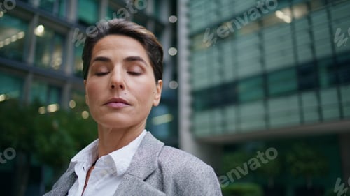 Preview: Serious executive look camera at office building closeup. Middle aged manager