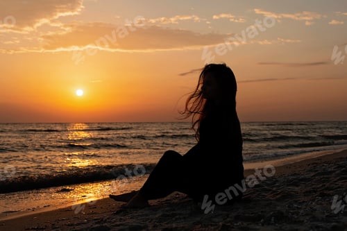 Preview: Colorful sunset on a sandy beach, waves with foam on the sand. Ocean, coast.