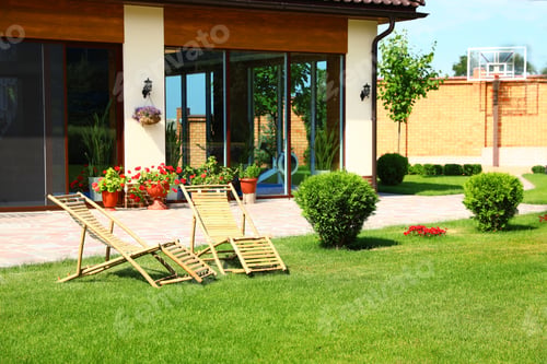 Preview: Wooden deck chairs in beautiful garden on sunny day
