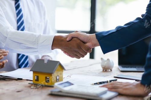 Preview: Close up shake hands, Considering buying a home, investing in real estate. Broker signs a sales