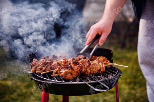 Preview: Grilling Meat Skewers Over Hot Charcoal at Outdoor BBQ