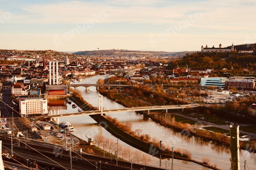 Preview: Aerial shot of a river going through an old town captured on a cloudy day