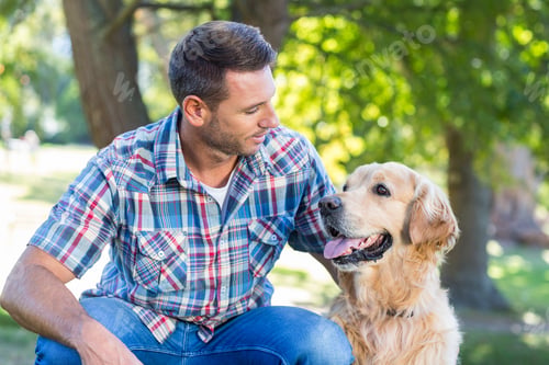 Preview: Happy Man With His Pet Dog In Park On A Sunny Day