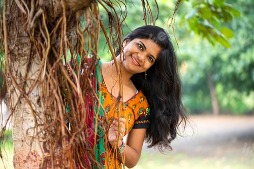Preview: Happy woman near banyan tree