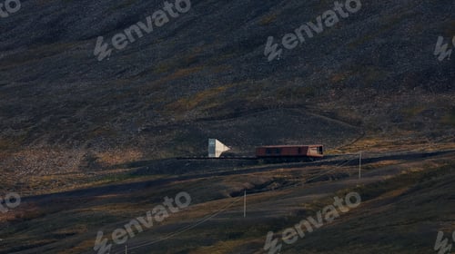 Preview: Remote Arctic landscape in Svalbard featuring a building amidst rugged terrain and clear sky