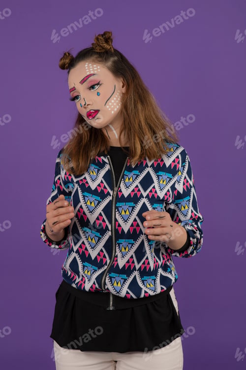 Preview: Young beautiful girl with fantasy makeup stand on purple background