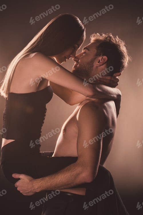 Preview: passionate lovers hugging and looking at each other, on brown