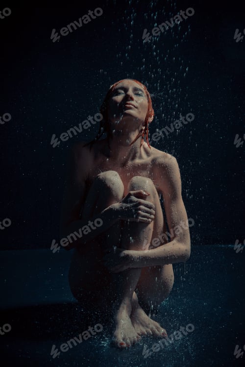 Preview: A Girl Sits On The Floor In The Rain.