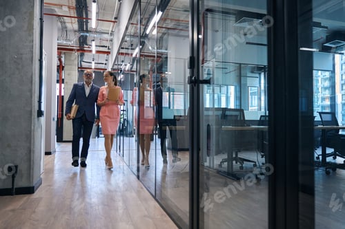 Preview: Couple of employees business company walk along corridor office building