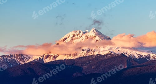 Preview: Snow Covered Canadian Rocky Mountain peaks. Sunny Cloudy Sunset