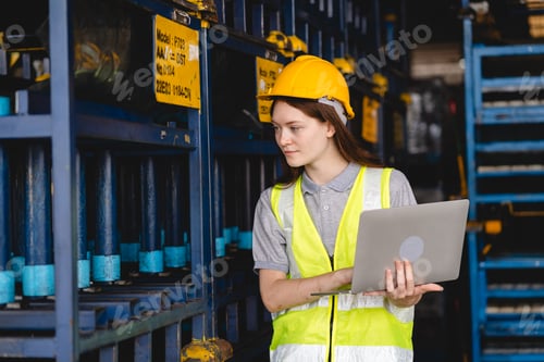 Preview: Female engineer using laptop computer for safety control checks or manufacturing maintenance
