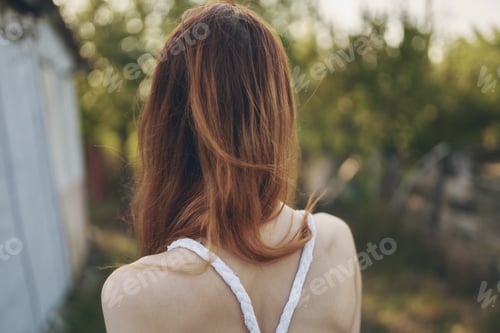 Preview: happy traveler in countryside near buildings outdoors trees back view
