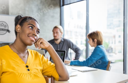 Preview: Young designer black woman with team giving new ideas project in conference room