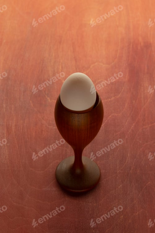 Preview: Egg in a glass placed on a wooden table