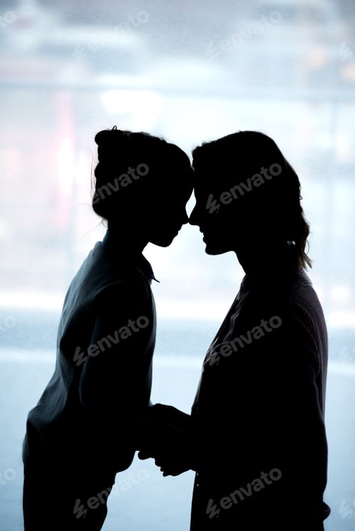 Preview: silhouettes of mother and daughter touching with foreheads at home